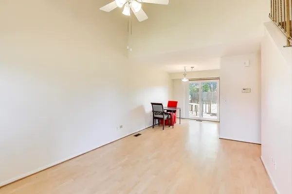 an empty room with furniture and a chandelier