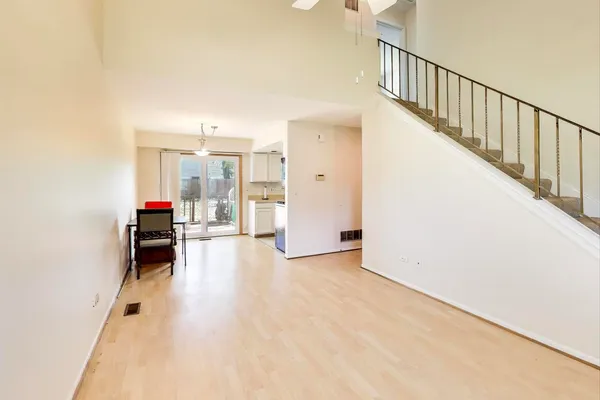 a view of a hallway with wooden floor and furniture