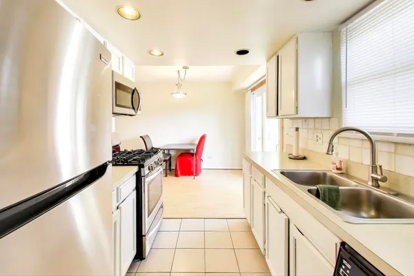 a kitchen with a sink and a stove top oven