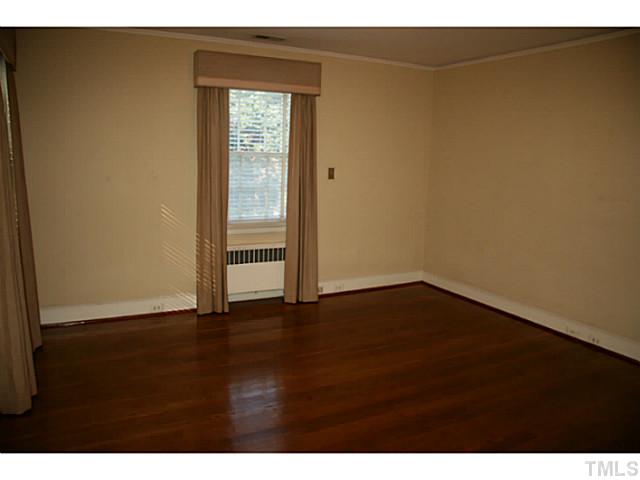 1001 Vance Street Raleigh, NC 27608 - Photo 12 of 15 a view of an empty room with wooden floor and a window