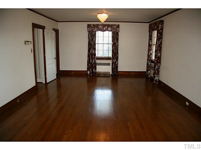 1001 Vance Street Raleigh, NC 27608 - Photo 13 of 15 a view of an empty room with wooden floor and a window