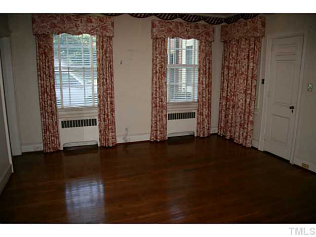 1001 Vance Street Raleigh, NC 27608 - Photo 15 of 15 a view of an empty room with wooden floor and a window