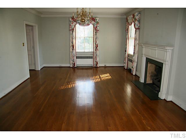 1001 Vance Street Raleigh, NC 27608 - Photo 4 of 15 a view of empty room with wooden floor and fireplace