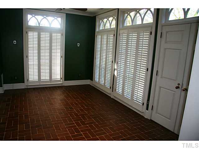 1001 Vance Street Raleigh, NC 27608 - Photo 5 of 15 a view of an empty room with wooden floor and a window