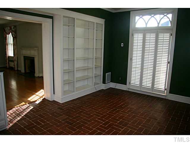 1001 Vance Street Raleigh, NC 27608 - Photo 6 of 15 a view of an empty room with wooden floor and a window