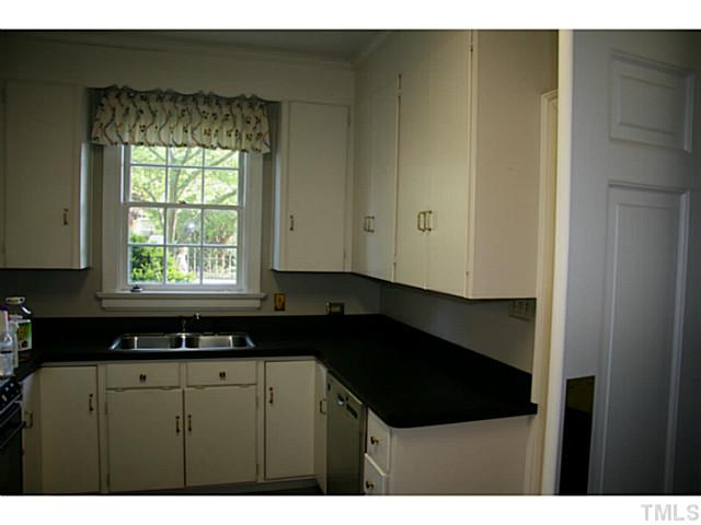 1001 Vance Street Raleigh, NC 27608 - Photo 8 of 15 a kitchen with a sink and cabinets