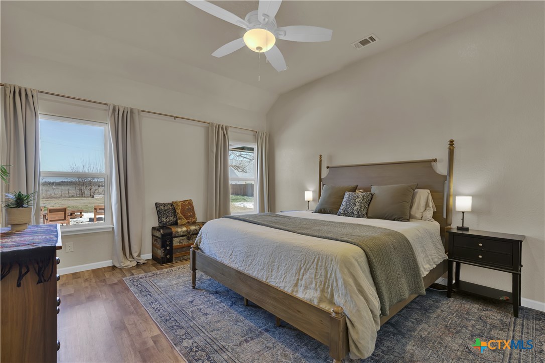 162 Friedens Church Road Seguin, TX 78155 - Photo 11 of 33 a bedroom with a bed and a chandelier