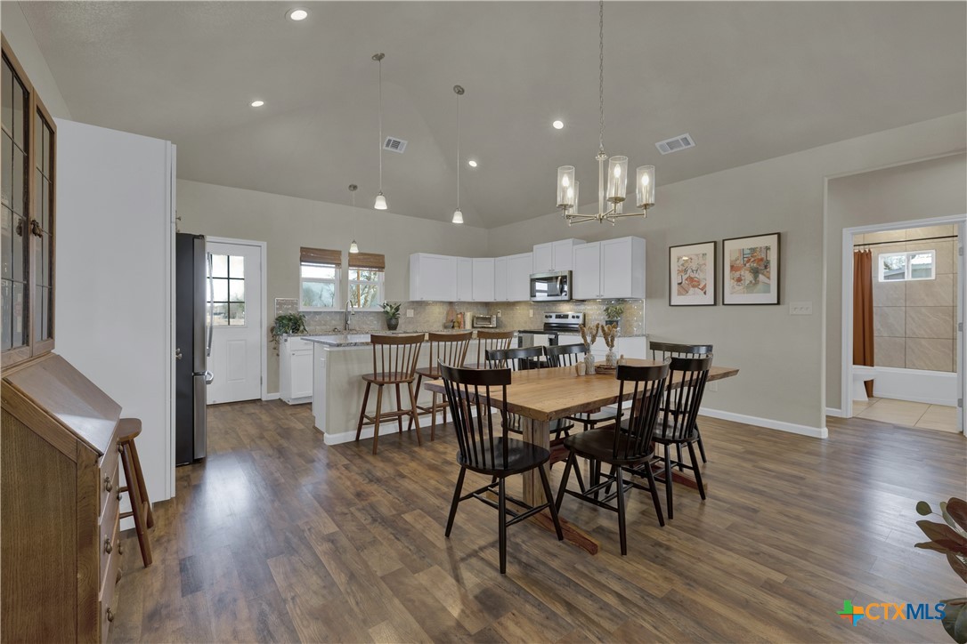 162 Friedens Church Road Seguin, TX 78155 - Photo 7 of 33 a view of a dining room with furniture and wooden floor