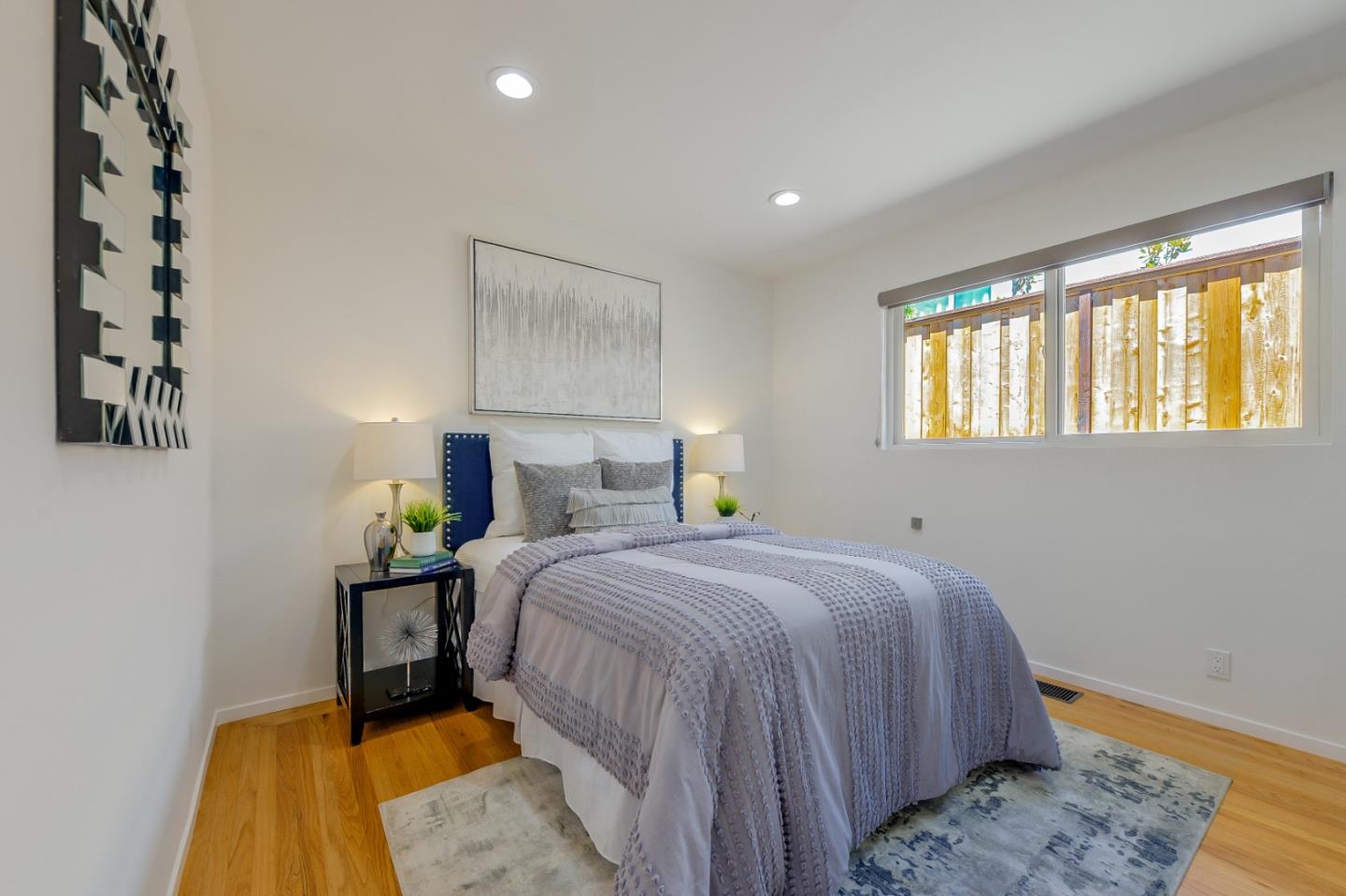 2839 Hillside Drive Burlingame, CA 94010 - Photo 18 of 43 a bedroom with a bed and wooden floor
