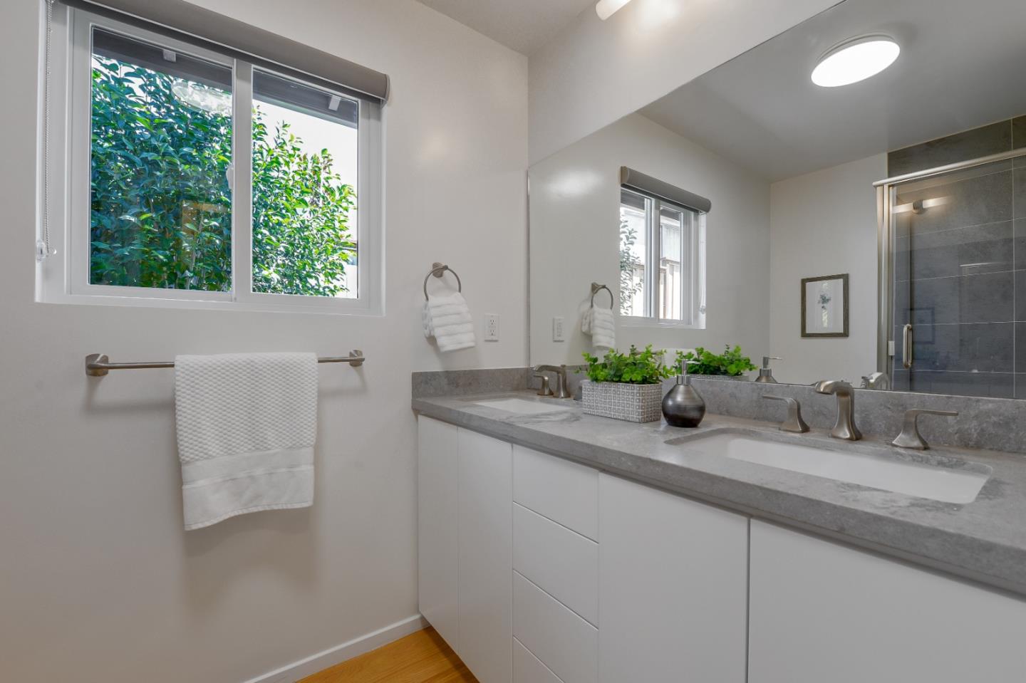 2839 Hillside Drive Burlingame, CA 94010 - Photo 29 of 43 a bathroom with a double vanity sink and mirror