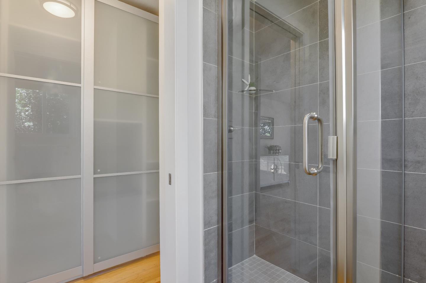 2839 Hillside Drive Burlingame, CA 94010 - Photo 30 of 43 a bathroom with a glass shower door