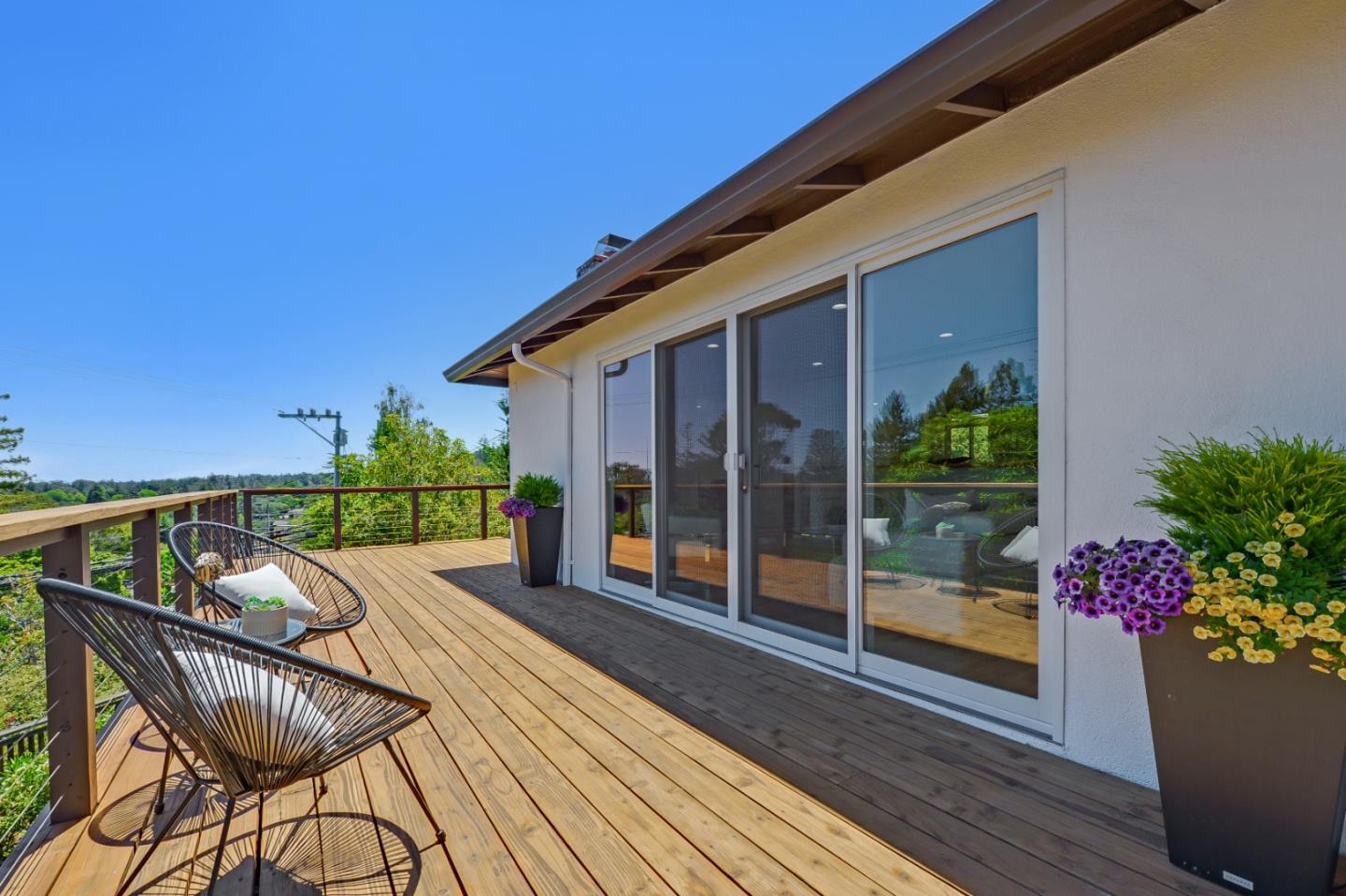 2839 Hillside Drive Burlingame, CA 94010 - Photo 37 of 43 a view of a patio with couches table and chairs potted plants with wooden floor and fence