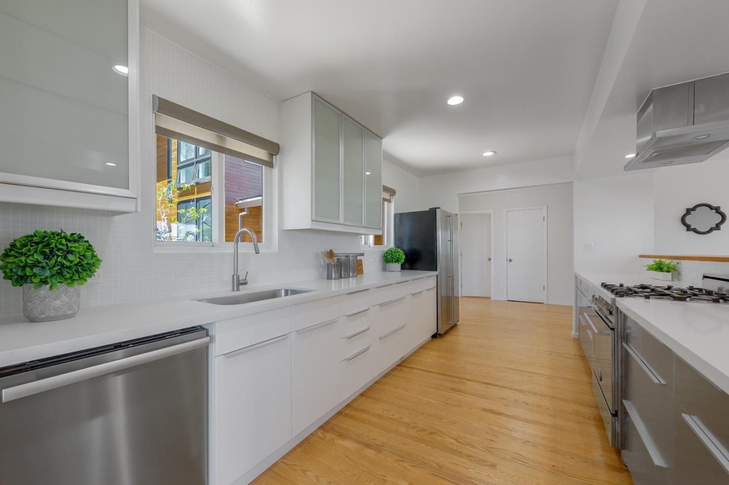 2839 Hillside Drive Burlingame, CA 94010 - Photo 8 of 43 a large kitchen with granite countertop a sink stainless steel appliances and cabinets