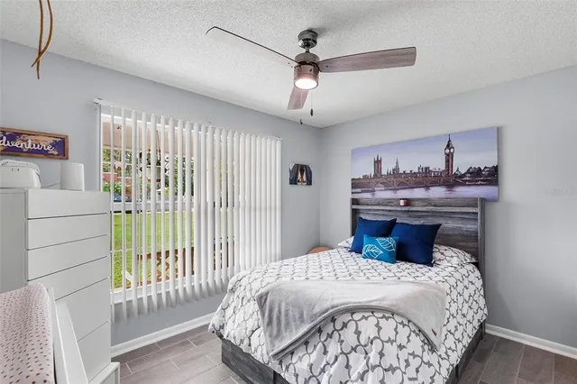 a bedroom with a large bed and a chandelier