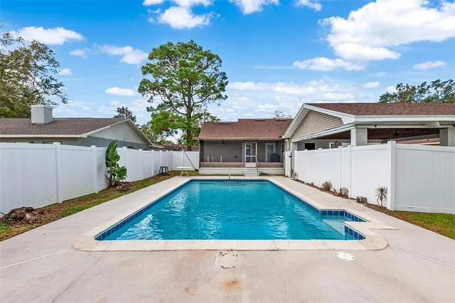 a view of house with swimming pool