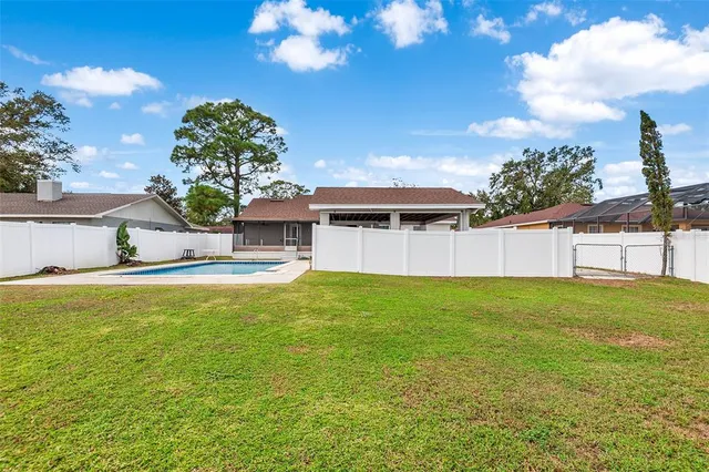 a backyard of a house with table and chairs