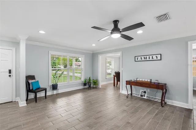 a living room with furniture and wooden floor