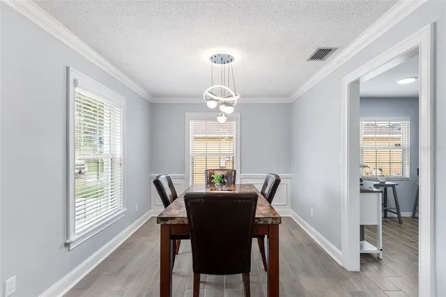a dining room with furniture and window