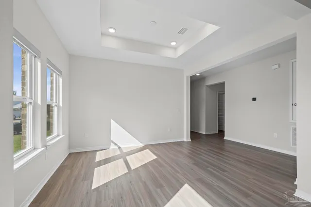 a kitchen with refrigerator and cabinets
