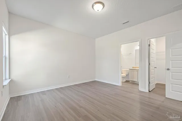a view of a house with a big yard and a large tree
