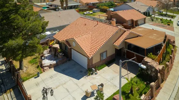 an aerial view of a house with a yard