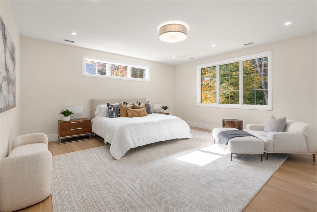 181 Wiswall Road Newton, MA 02459 - Photo 19 of 35 a spacious bedroom with a bed and a couch