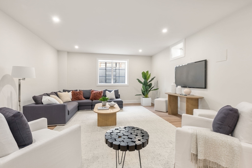 181 Wiswall Road Newton, MA 02459 - Photo 25 of 35 a living room with furniture and a flat screen tv