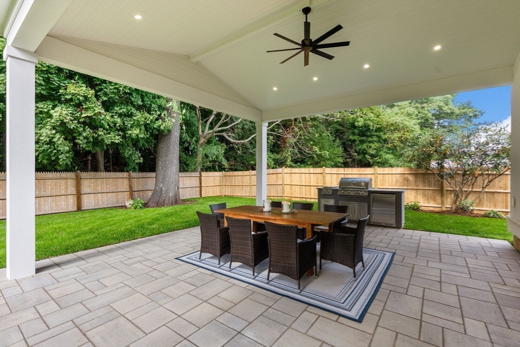 181 Wiswall Road Newton, MA 02459 - Photo 29 of 35 a view of a patio with a dining table and chairs