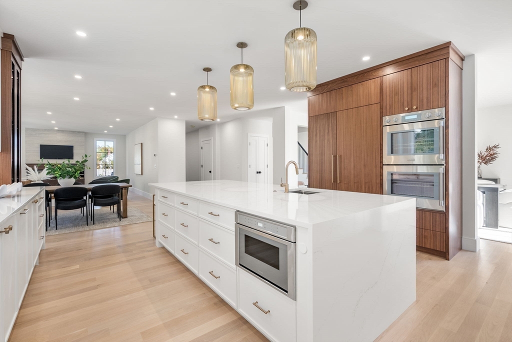181 Wiswall Road Newton, MA 02459 - Photo 3 of 35 a large kitchen with stainless steel appliances kitchen island granite countertop a large kitchen island a stove and a sink