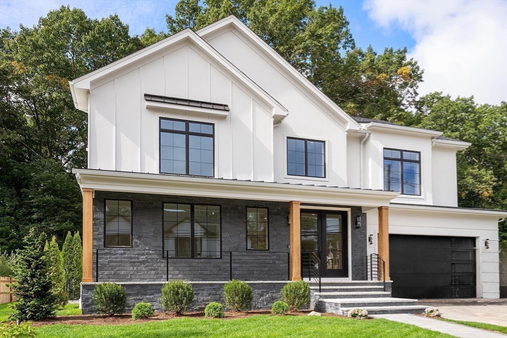 181 Wiswall Road Newton, MA 02459 - Photo 34 of 35 a view of a white house with large windows and a yard