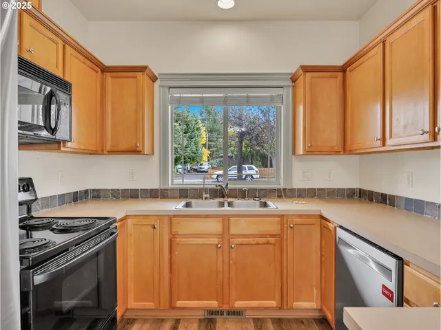 a kitchen with a sink stove and cabinets