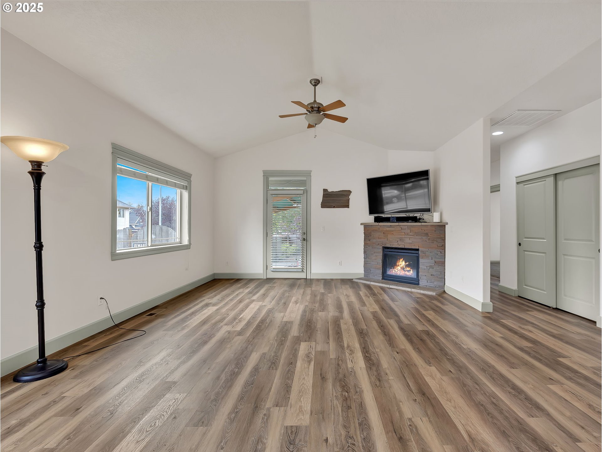 3279 Southeast Anderson Road Gresham, OR 97080 - Photo 12 of 42 wooden floor fireplace and windows in an empty room