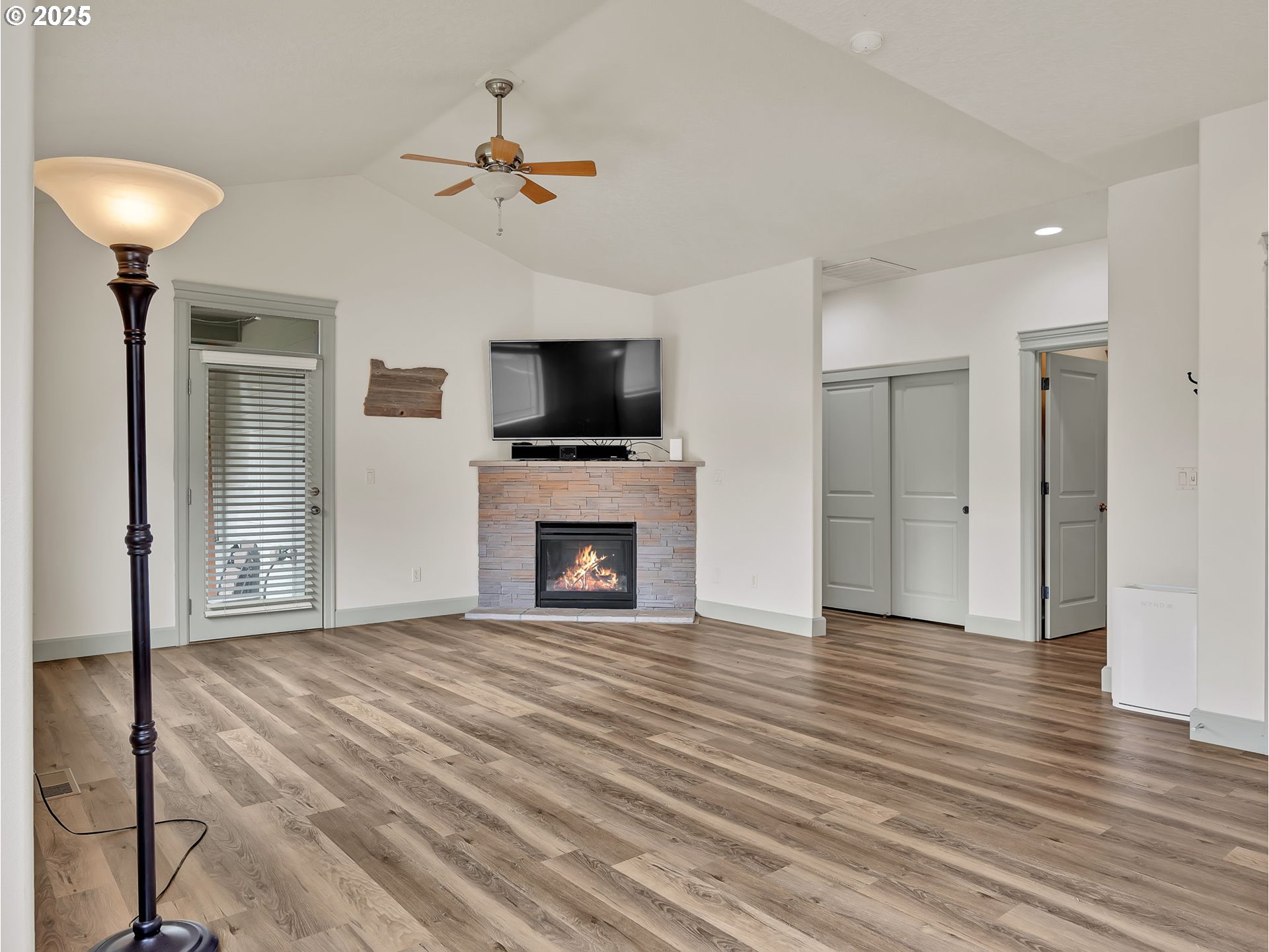 3279 Southeast Anderson Road Gresham, OR 97080 - Photo 13 of 42 a view of a livingroom with a fireplace a chandelier and wooden floor