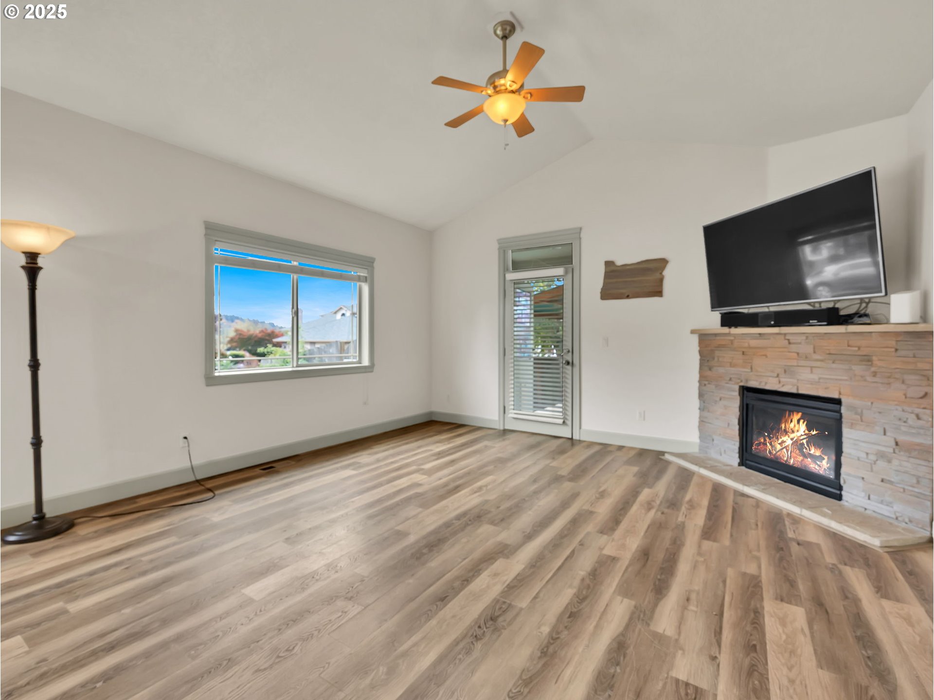 3279 Southeast Anderson Road Gresham, OR 97080 - Photo 15 of 42 a view of empty room with a fireplace and flat screen tv