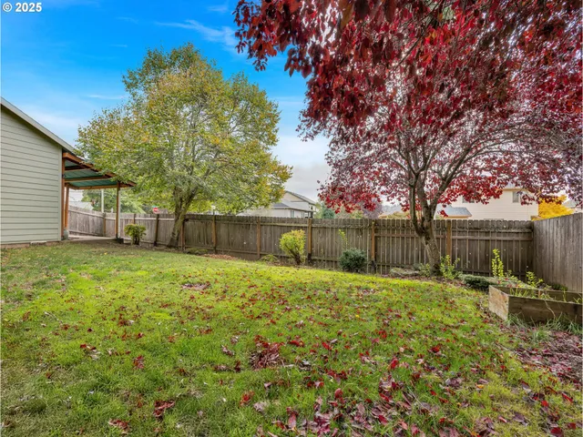 a backyard of a house with lots of green space and garden