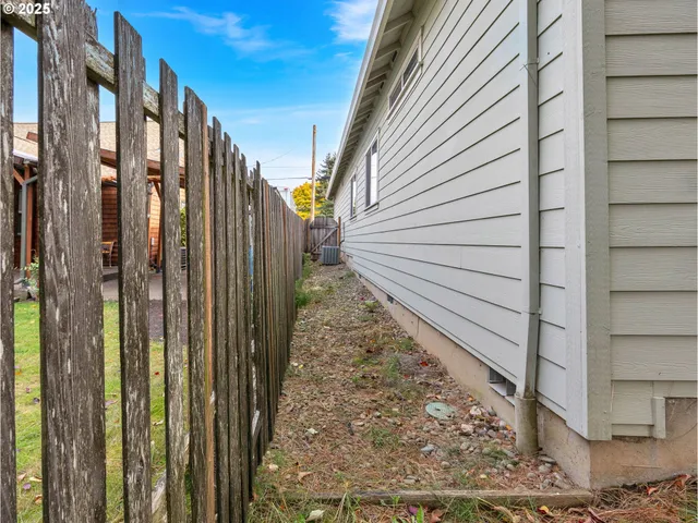a view of a yard in front of a house with large trees