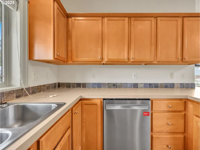 a kitchen with stainless steel appliances granite countertop a sink and a microwave