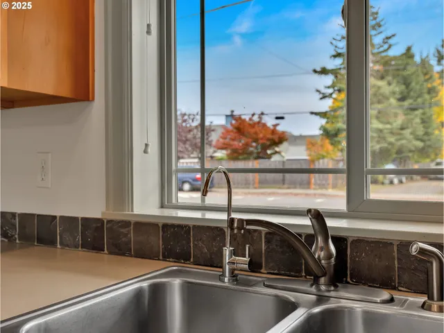 a kitchen sink with a cabinet and mirror
