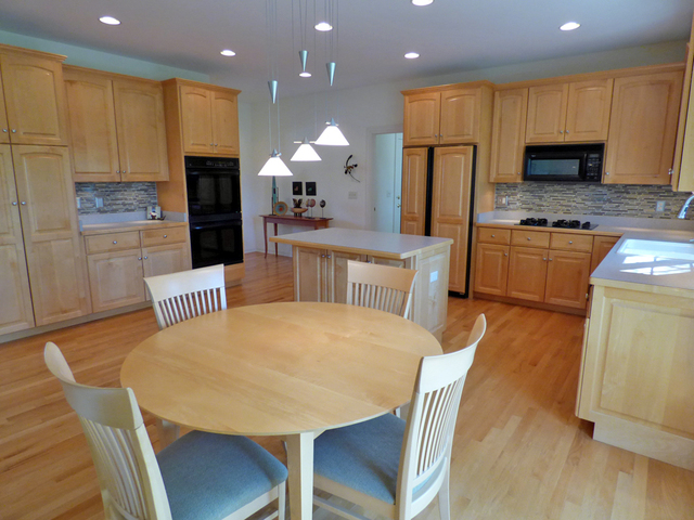 S130 Forbes Drive Geneva, IL 60134 - Photo 11 of 45 a kitchen with stainless steel appliances granite countertop a table chairs sink refrigerator and microwave