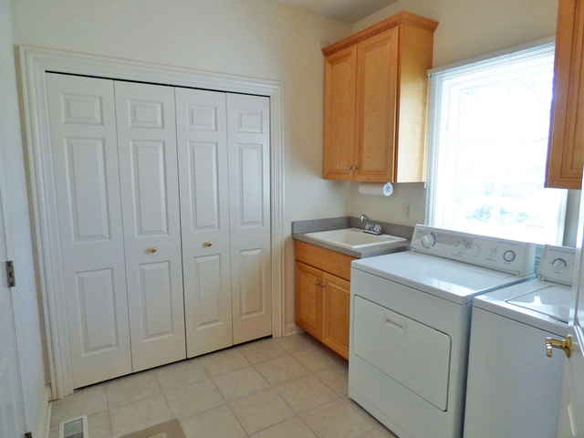 S130 Forbes Drive Geneva, IL 60134 - Photo 20 of 45 a utility room with cabinets washer and dryer