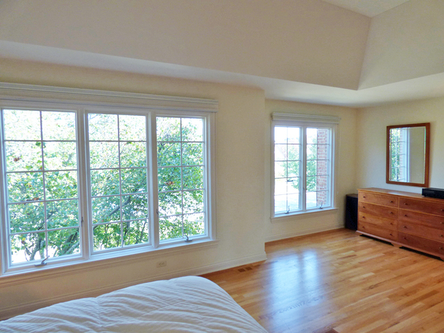 S130 Forbes Drive Geneva, IL 60134 - Photo 22 of 45 a view of an empty room with wooden floor and a window