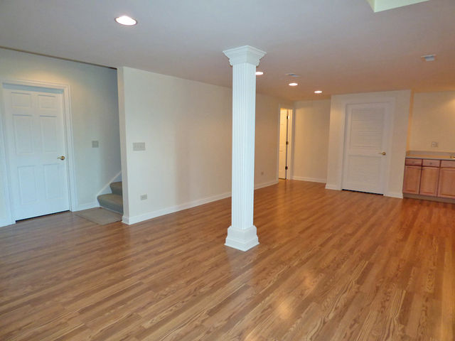 S130 Forbes Drive Geneva, IL 60134 - Photo 32 of 45 a view of empty room with wooden floor