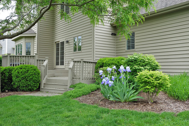 S130 Forbes Drive Geneva, IL 60134 - Photo 39 of 45 a view of a house with a yard and a garden