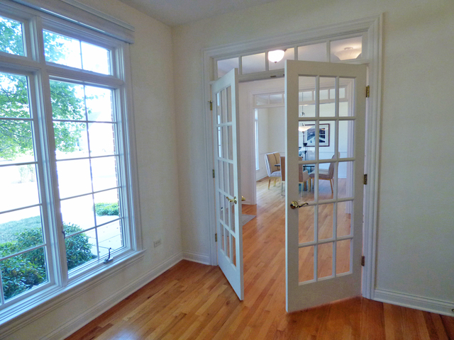 S130 Forbes Drive Geneva, IL 60134 - Photo 7 of 45 a view of a room with wooden floor and windows