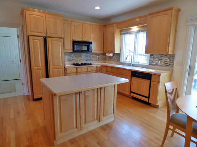 S130 Forbes Drive Geneva, IL 60134 - Photo 10 of 45 a kitchen with stainless steel appliances granite countertop a stove a sink dishwasher a microwave oven and a refrigerator with wooden floor