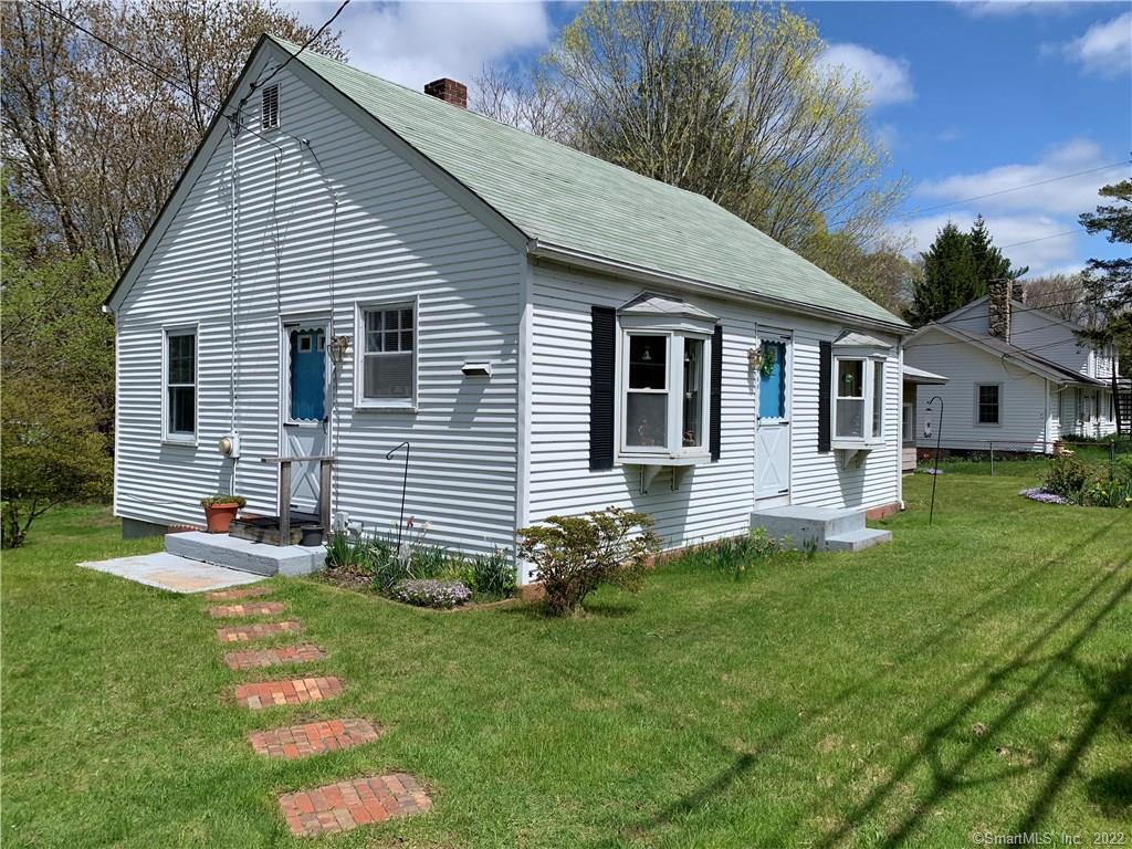 a front view of a house with a yard and porch