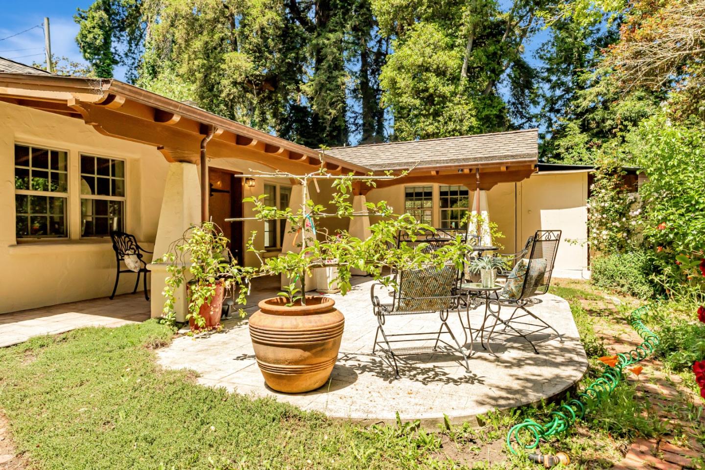 361 Moosehead Drive Aptos, CA 95003 - Photo 3 of 37 a view of a patio with table and chairs potted plants and large tree