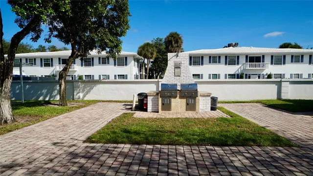 a front view of a house with a yard and shrubs