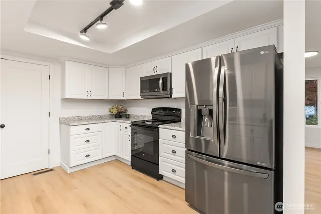 a kitchen with appliances cabinets and a sink