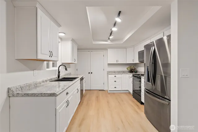 a kitchen with granite countertop a sink and a window